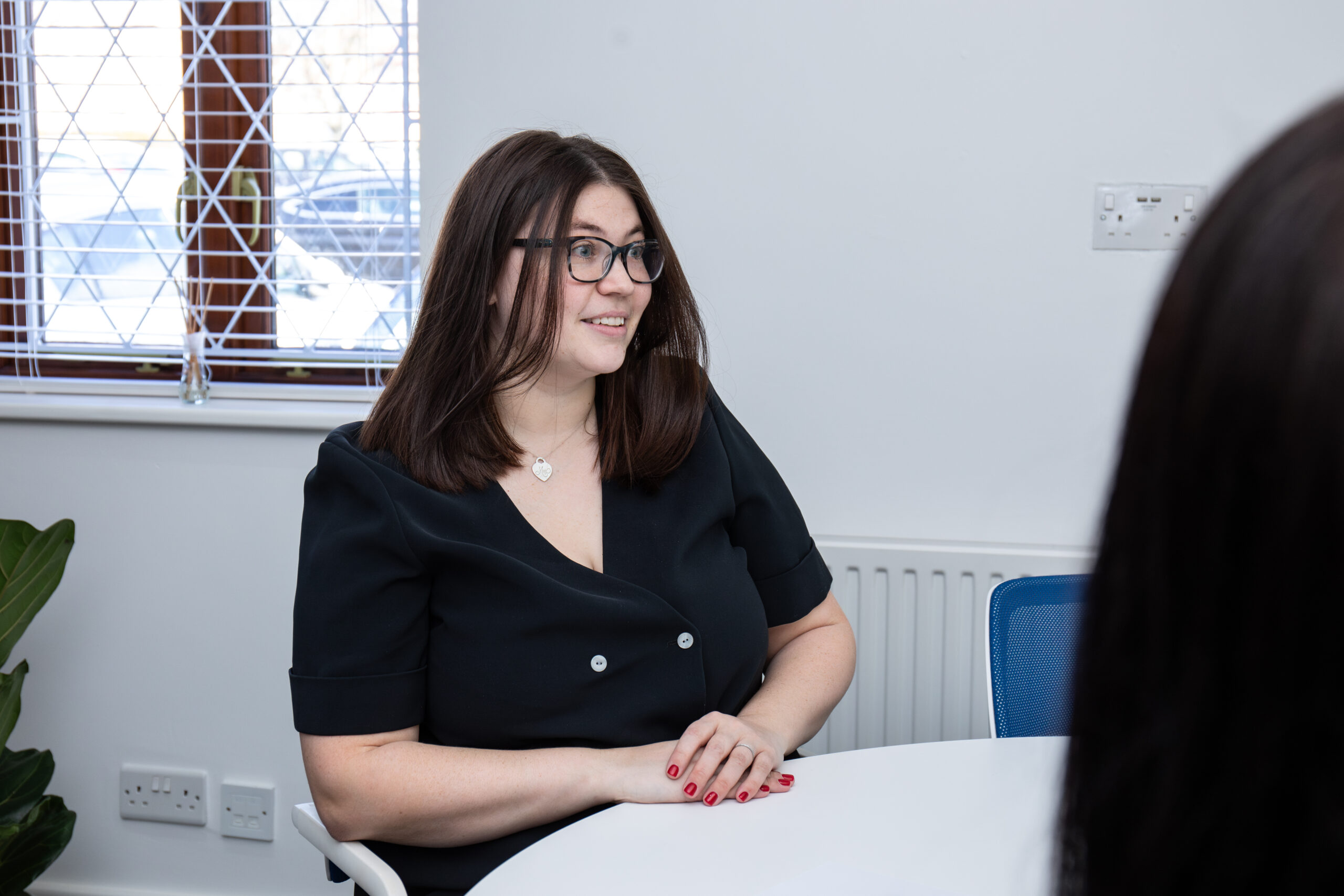 maxengel-2025-62 Woman in meeting at a modern office table.